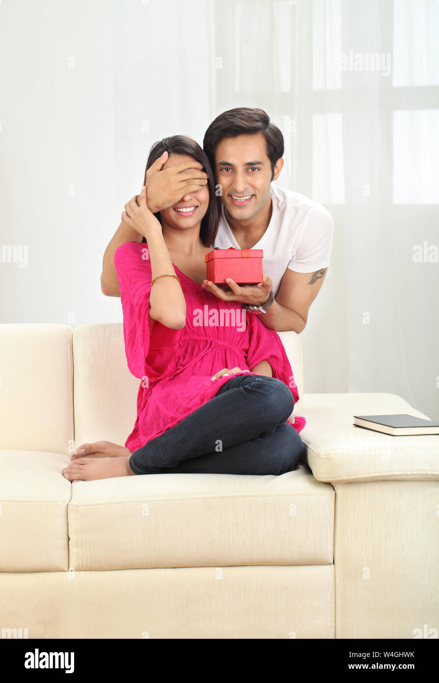 Man giving a gift to his wife Stock Photo Alamy