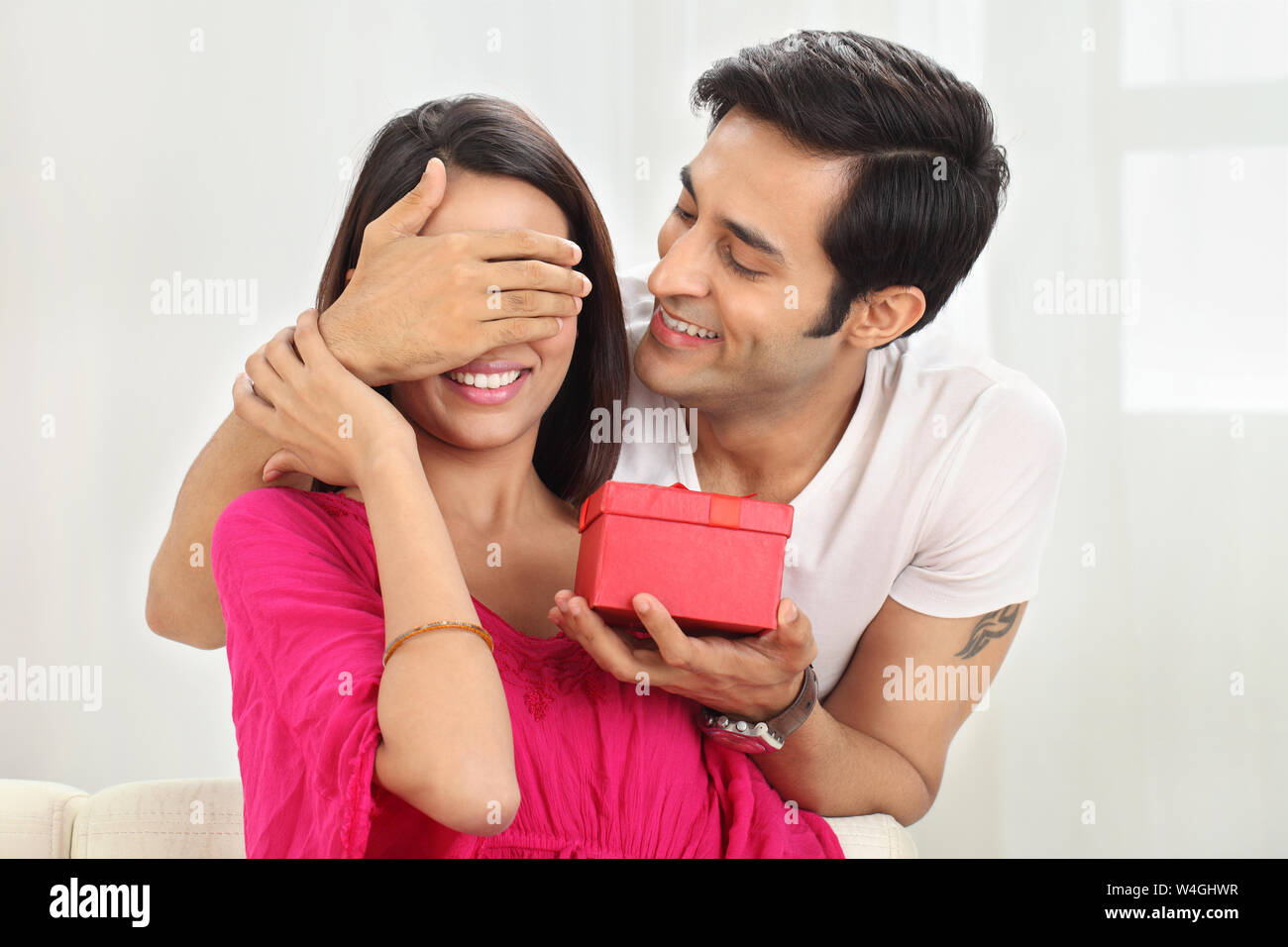 Man giving a gift to his wife Stock Photo Alamy