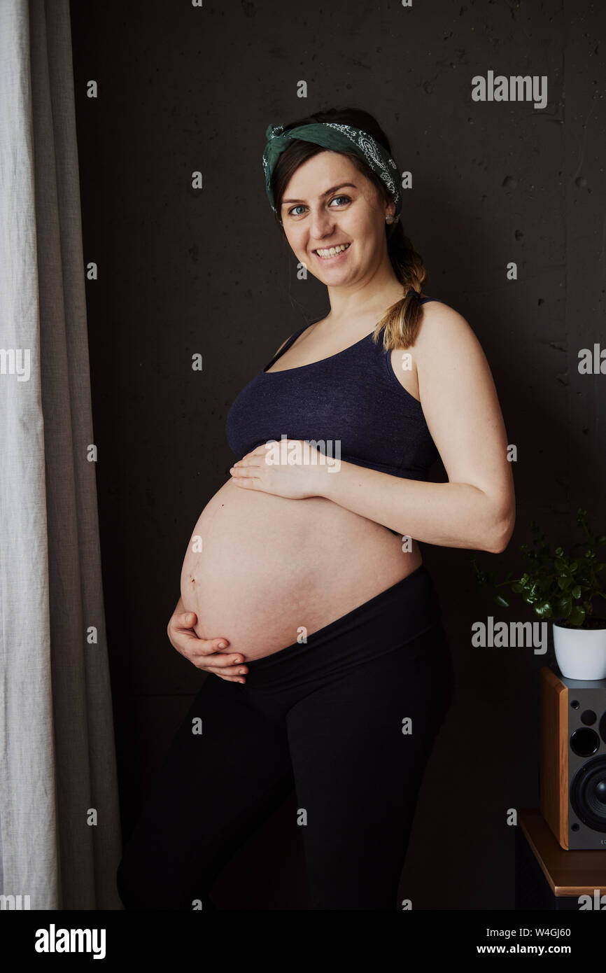 Pregnant woman holding her baby belly