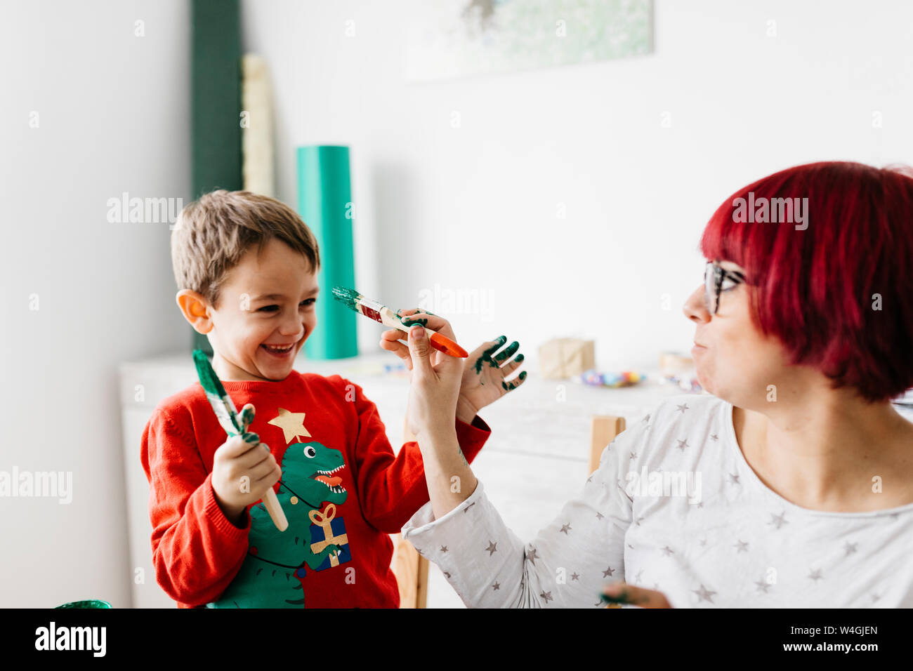 Mother and son having fun while doing crafts at home Stock Photo