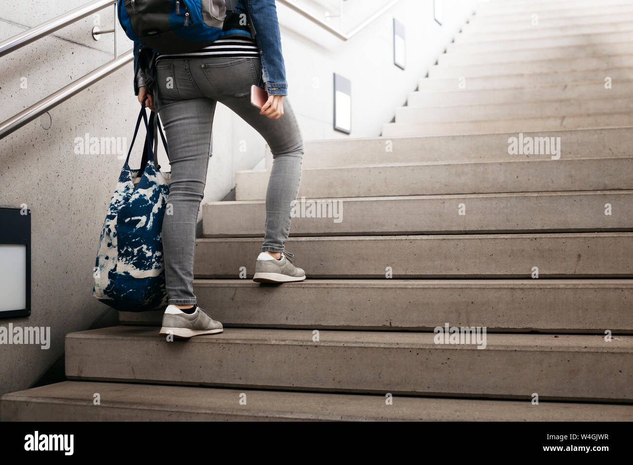 Person walking up stairs hi-res stock photography and images - Alamy