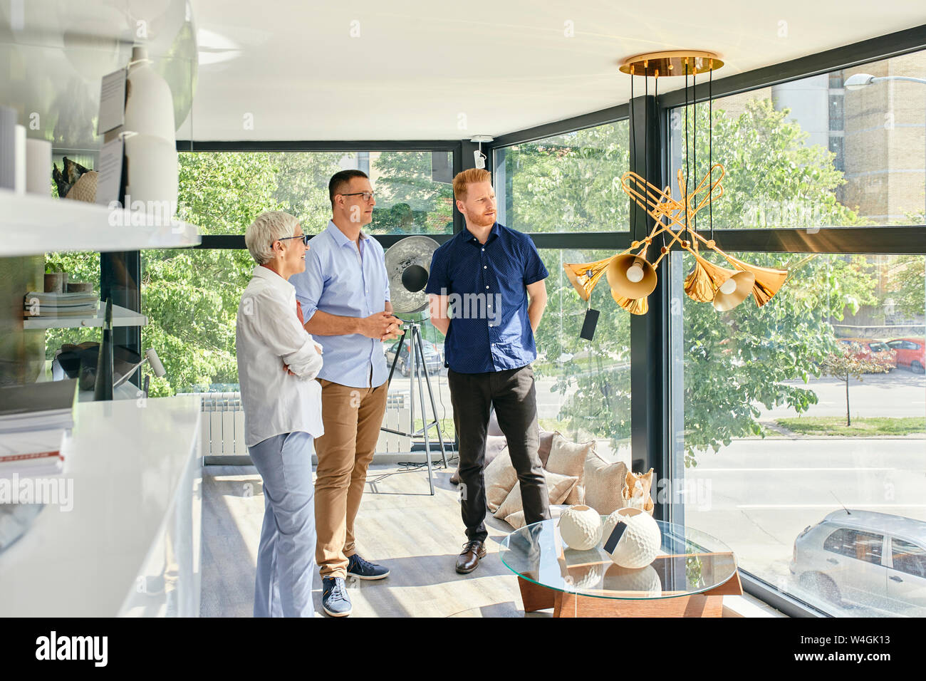 People looking out of window in a furniture showroom Stock Photo