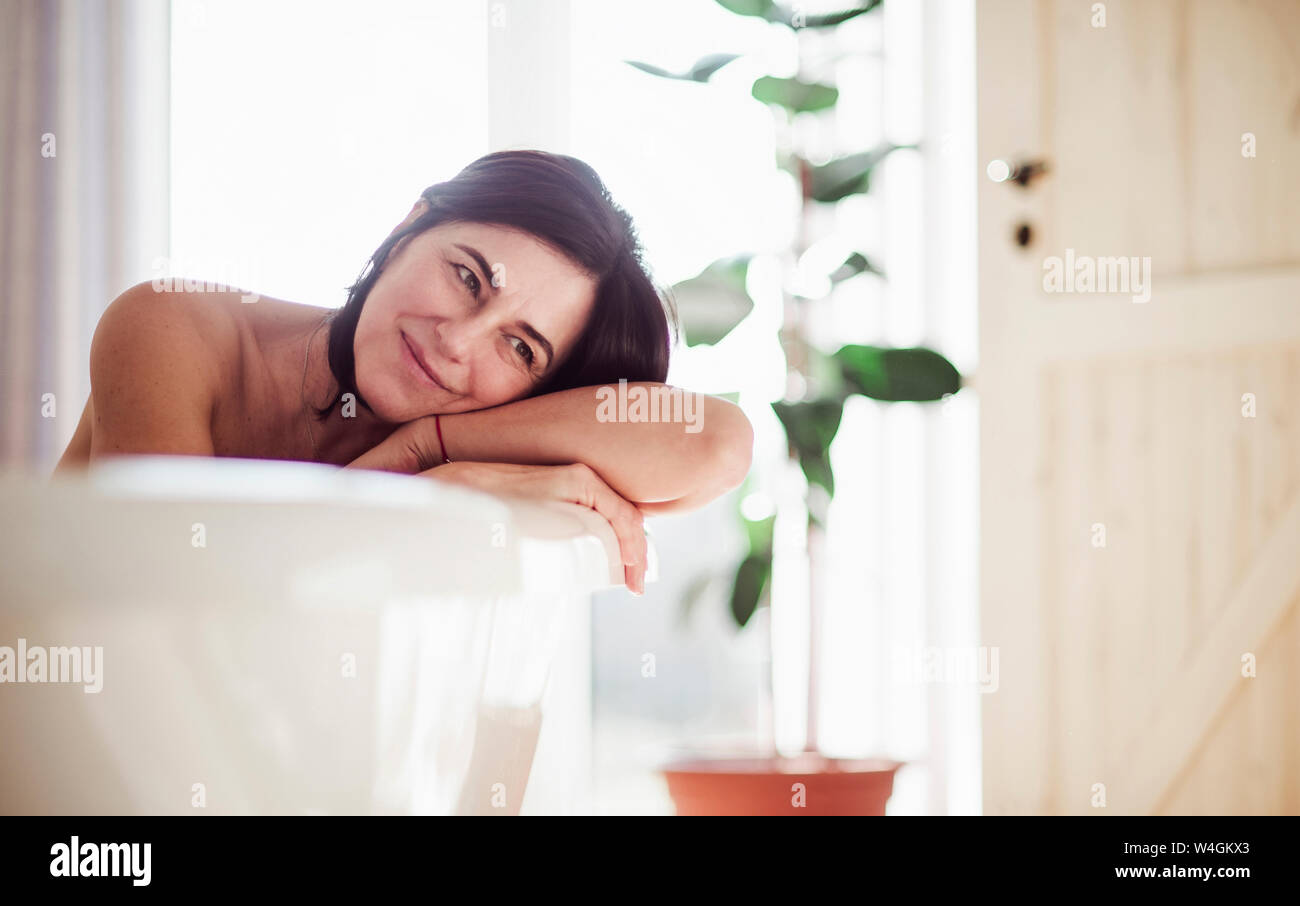 Mature woman relaxing, taking a bath Stock Photo