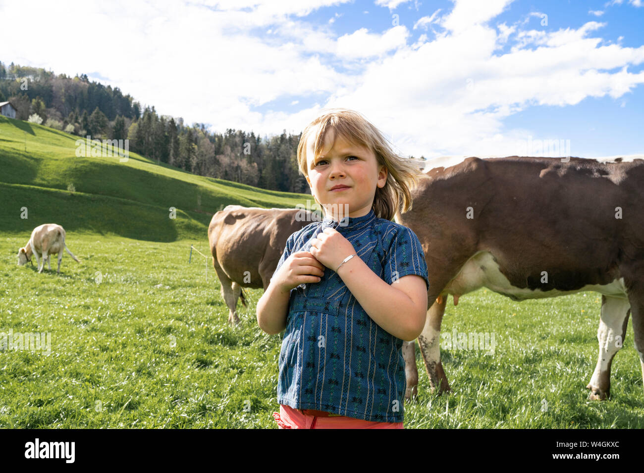 Girl with cows on pasture Stock Photo - Alamy