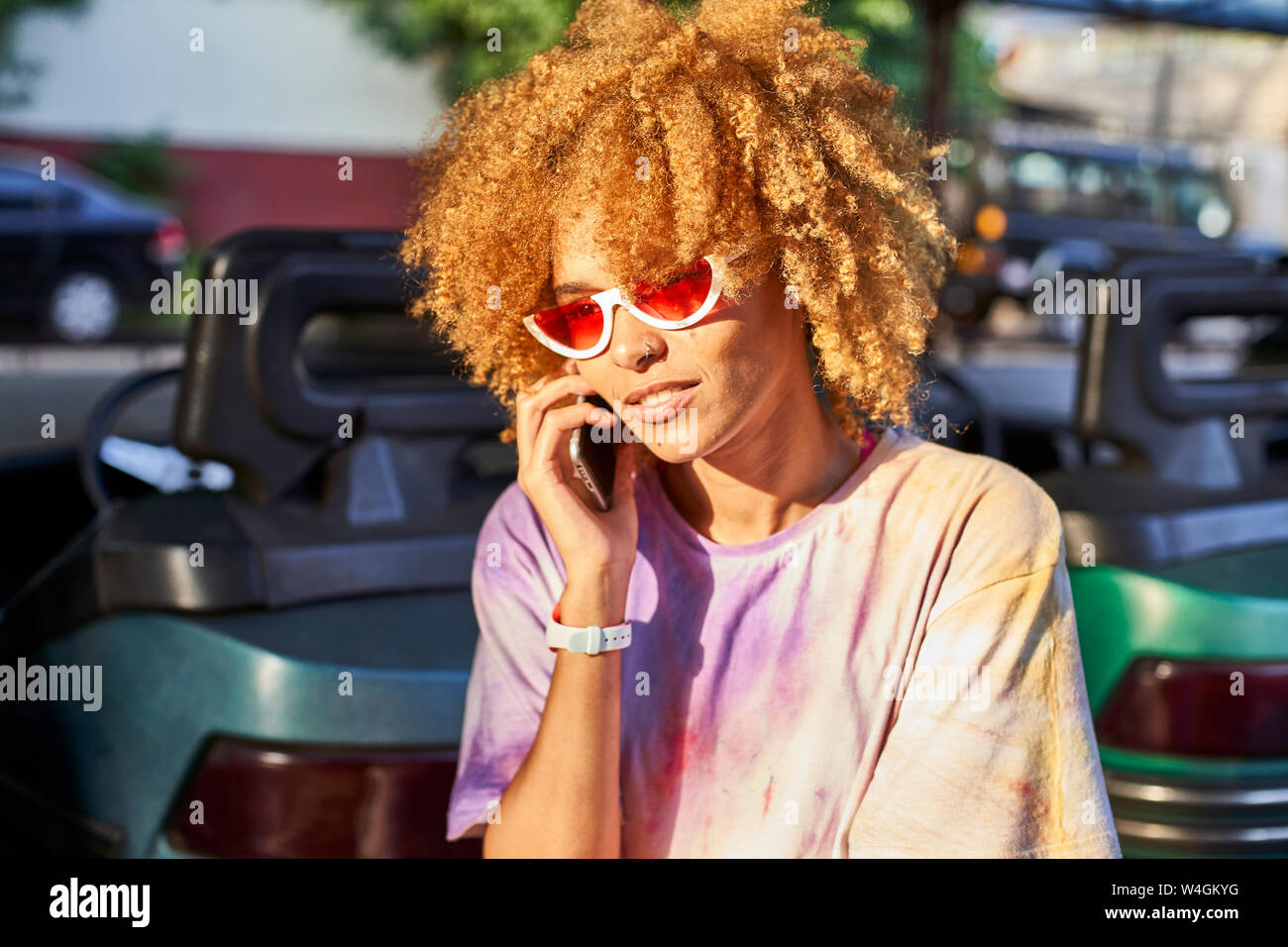 Woman on cell phone at bumper car on a fair Stock Photo