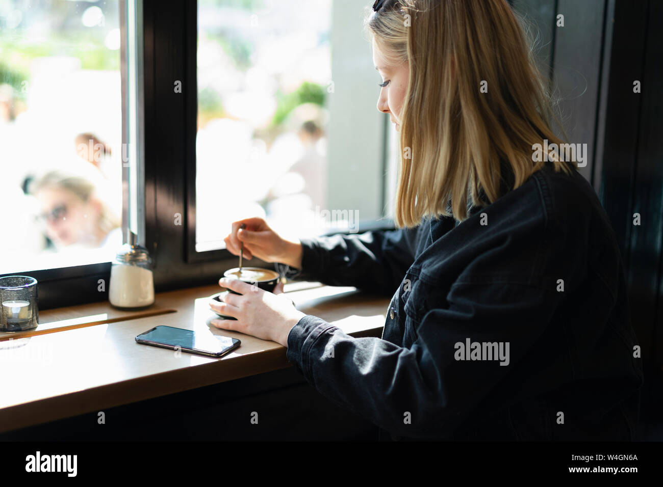 Young woman relaxing in a coffee shop Stock Photo - Alamy