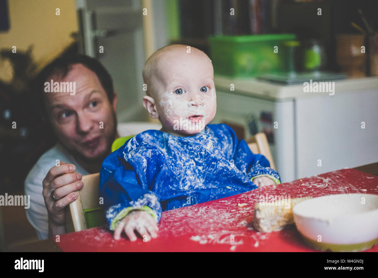 Father with his baby son after a messy meal Stock Photo