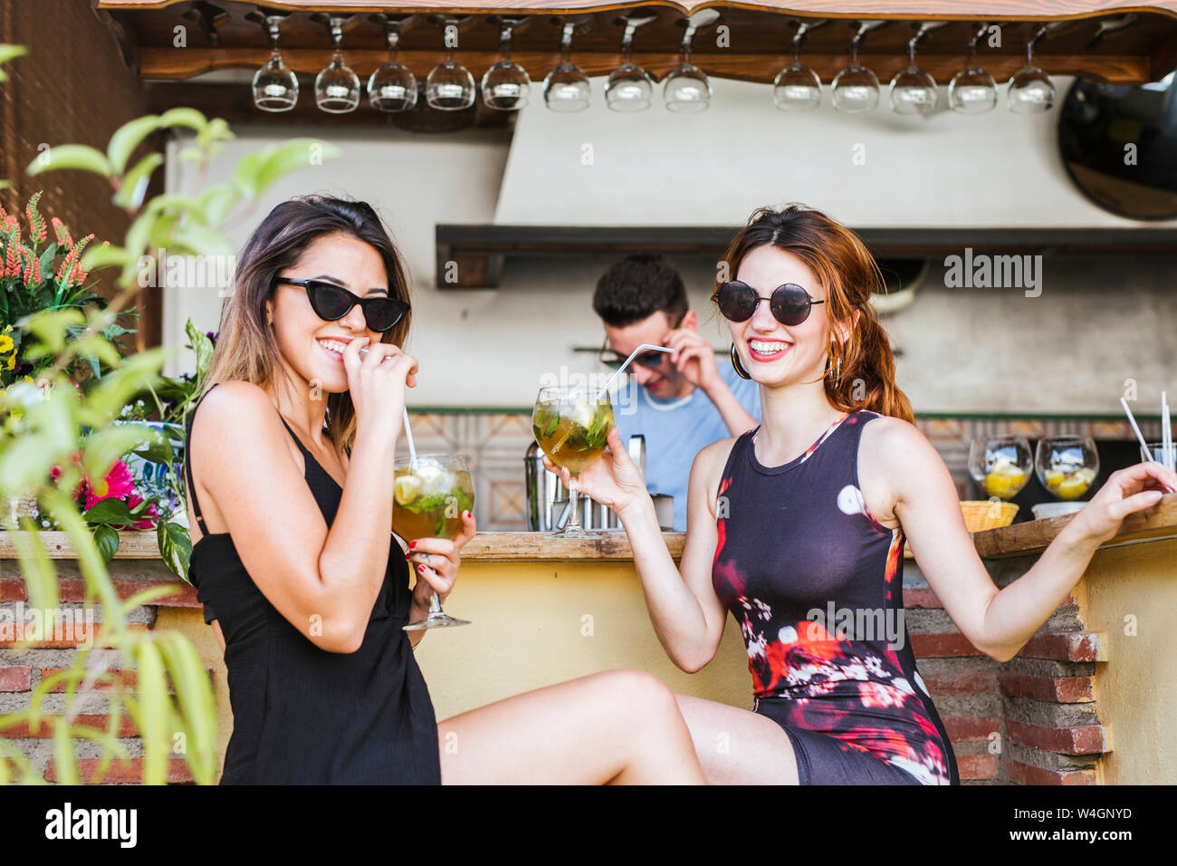 Two women having a drink at a bar Stock Photo