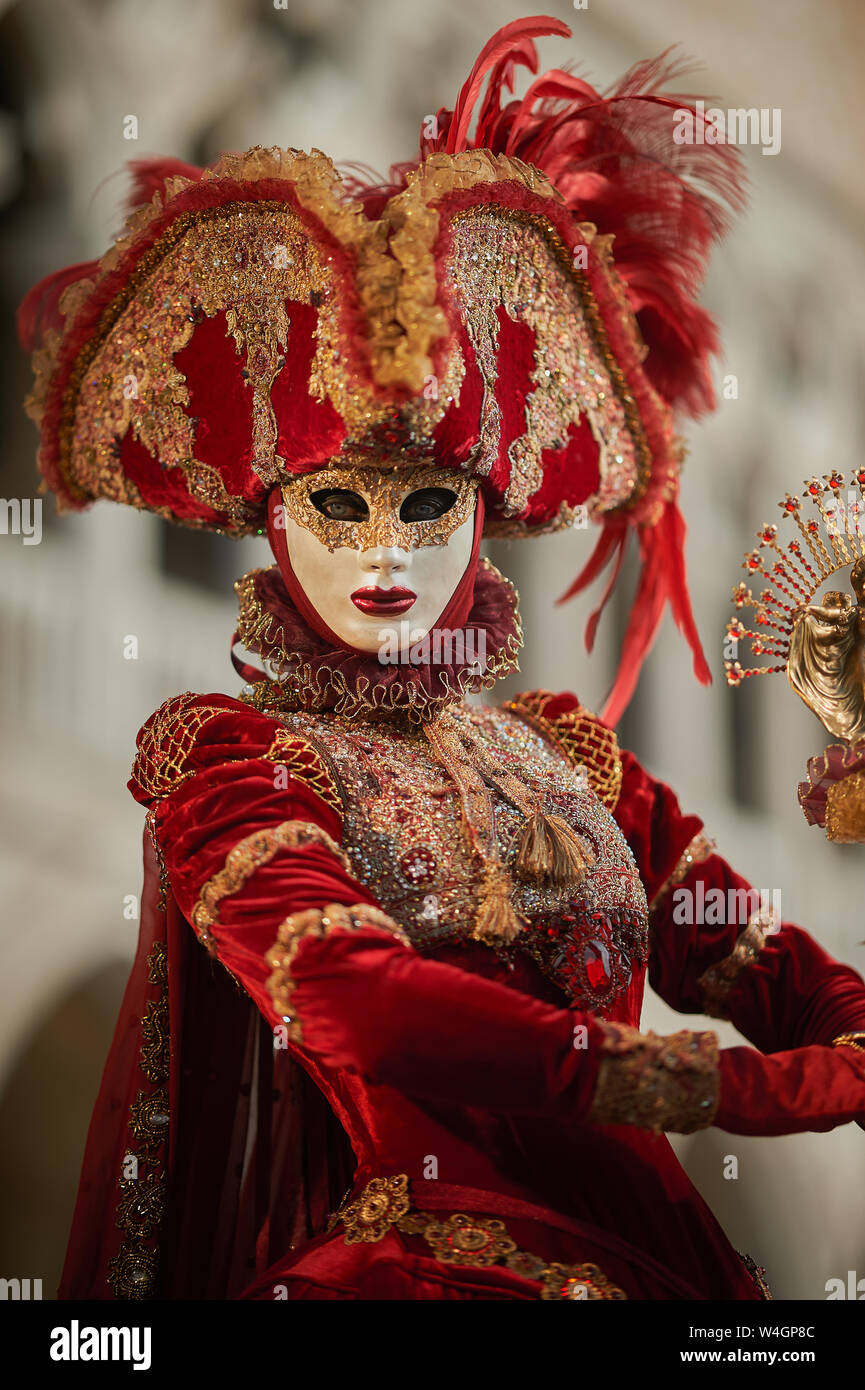 Venetian Masks in red costumes in Venice Italy Stock Photo - Alamy