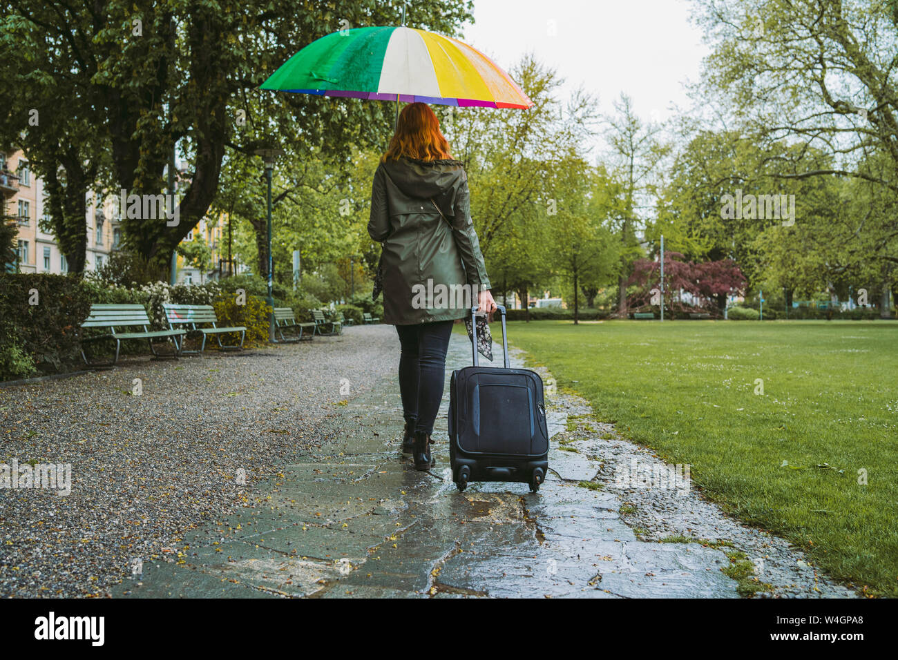 Woman walking in rain rear view hi-res stock photography and images - Alamy