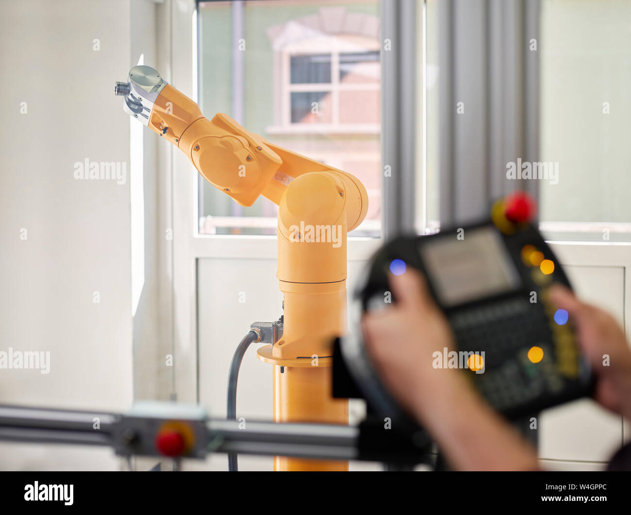 Hand-held control and robot arm Stock Photo