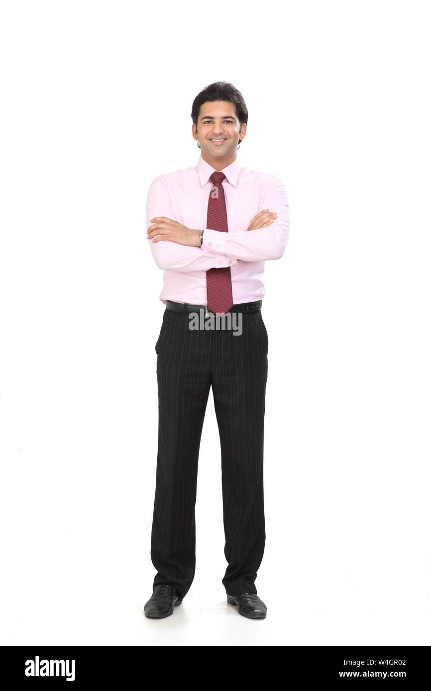 Businessman standing with his arms crossed and smiling Stock Photo - Alamy