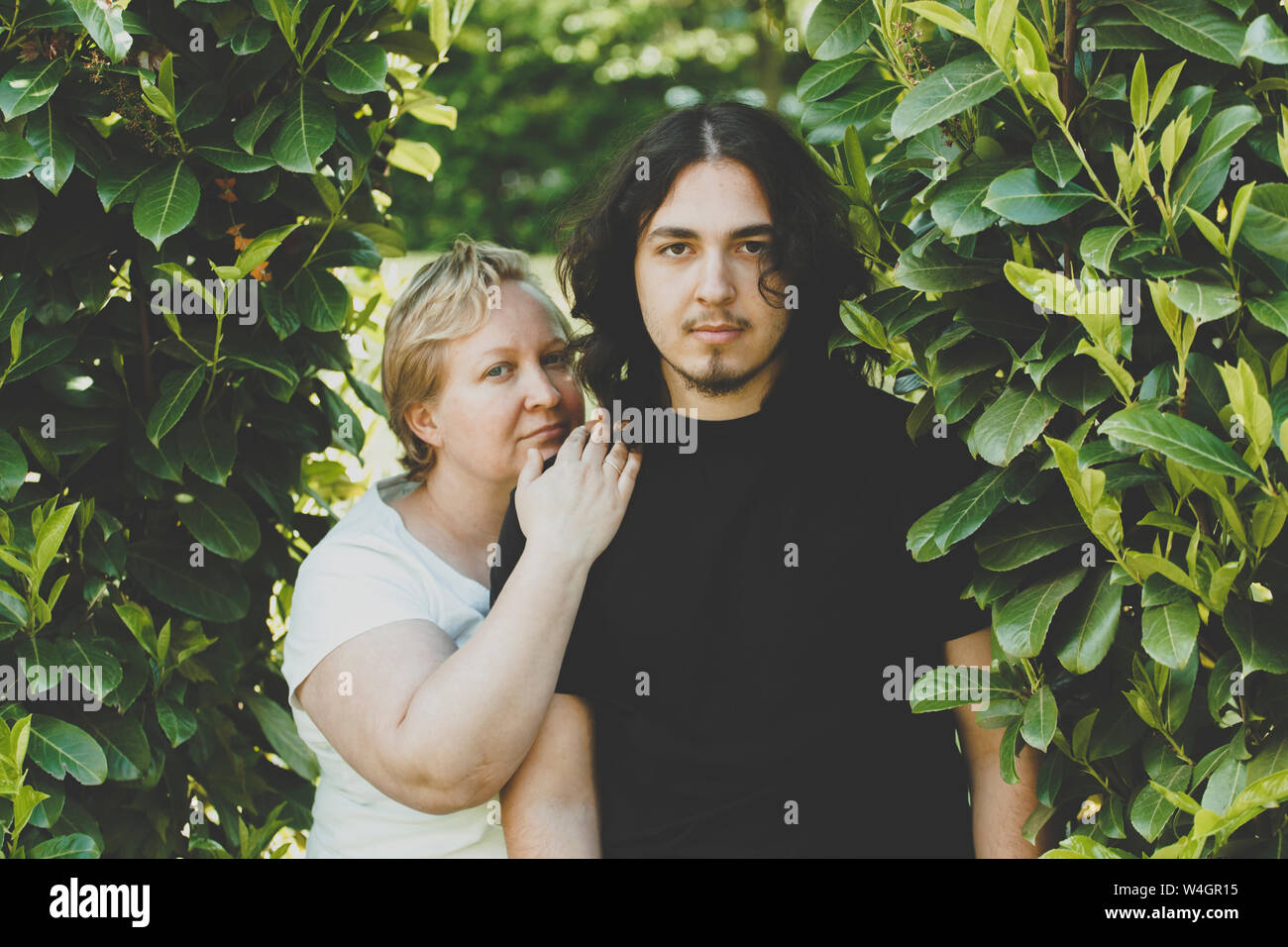 Mother and a teenage son looking at the camera Stock Photo