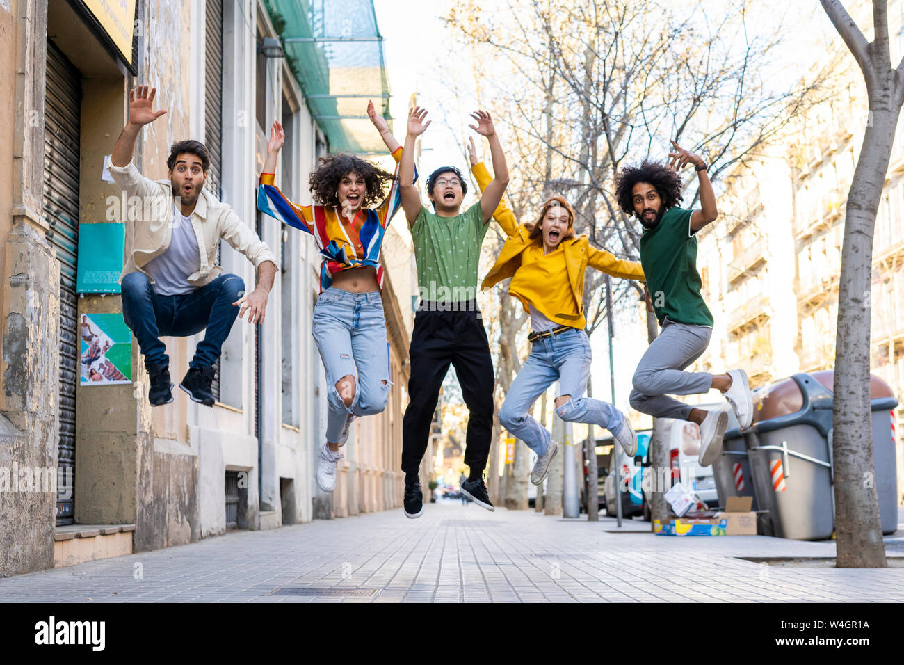 Happy group of friends having fun in the city jumping mid-air Stock ...