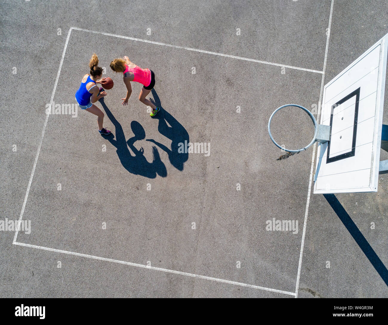 Young women playing basketball, aerial view Stock Photo