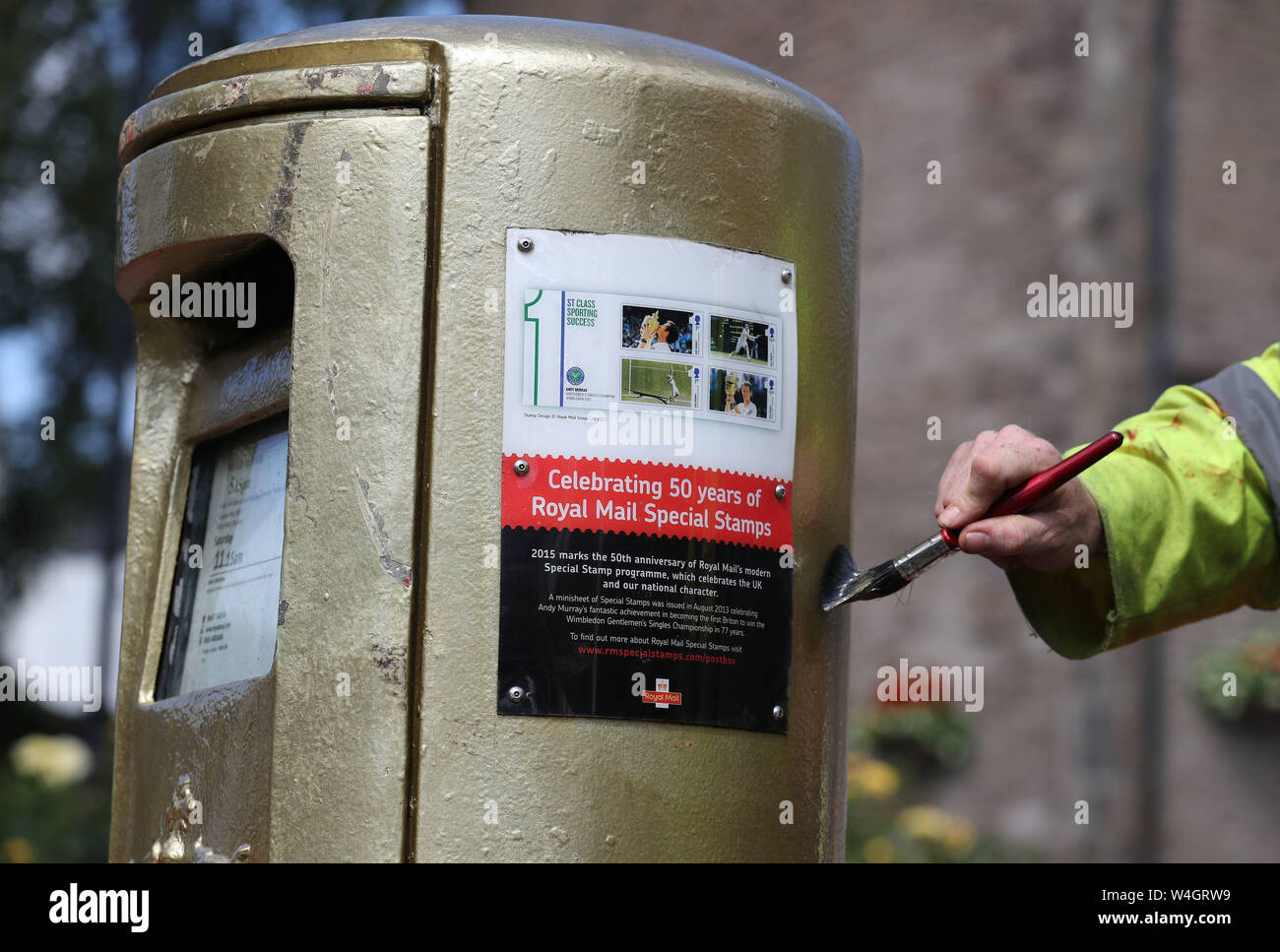 Workmen paint a post box in Dunblane after it was hit by a car last night.