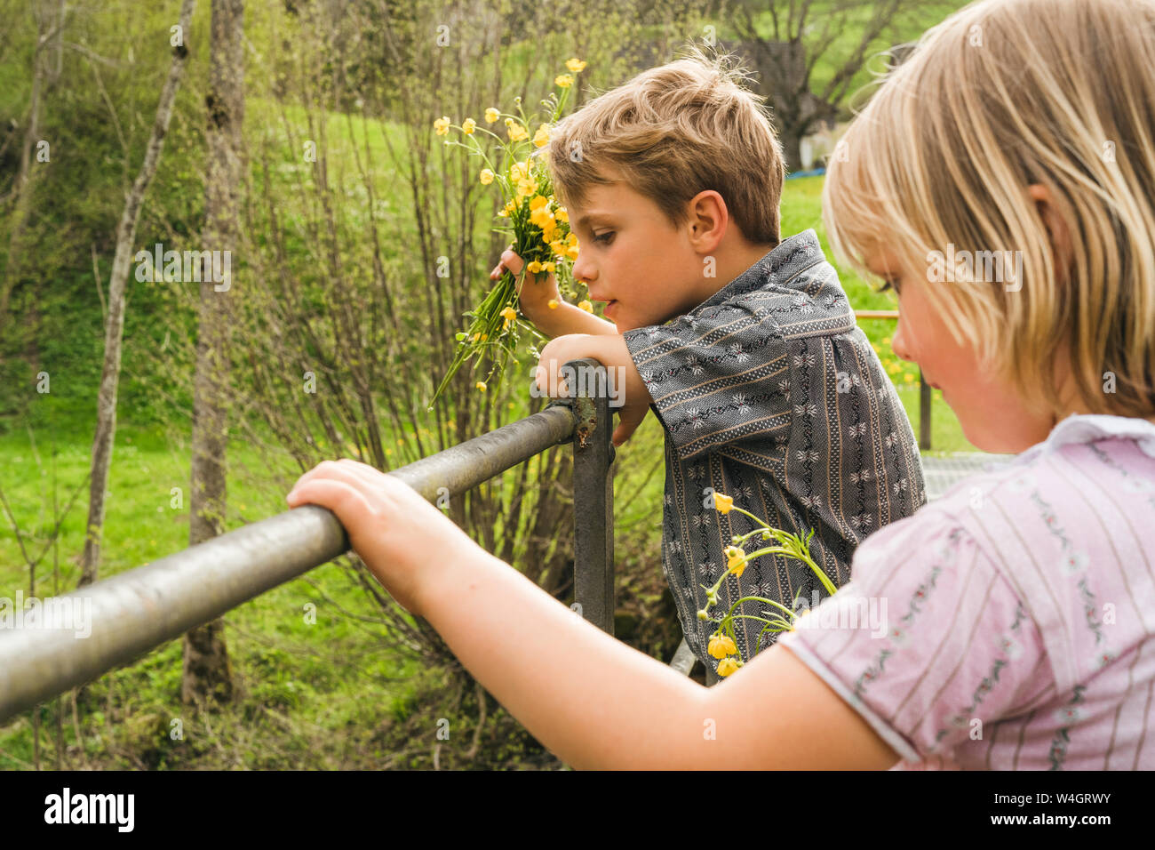 Two children on a bridge in the countryside Stock Photo - Alamy