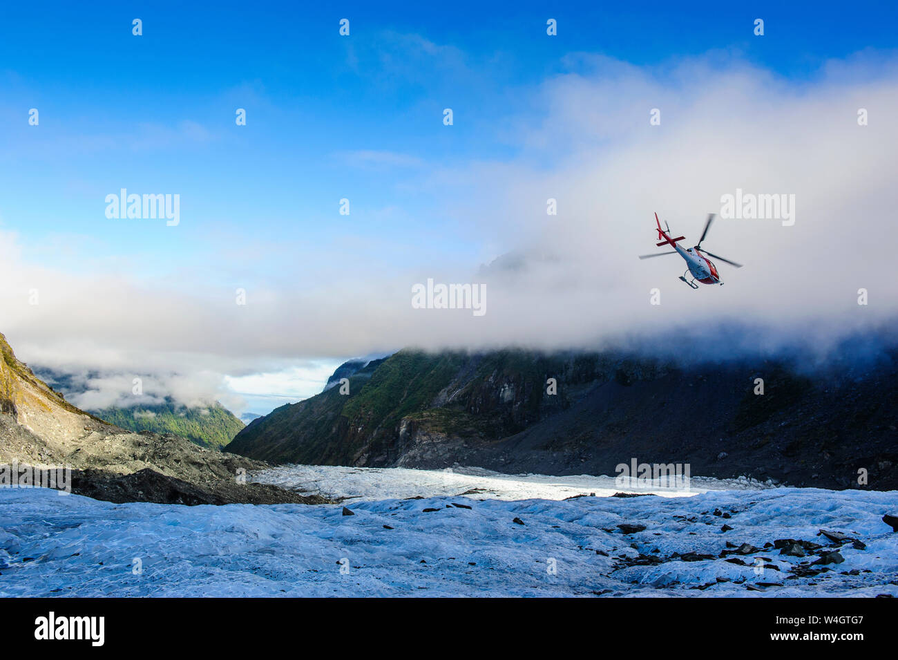 Helicopter transporting tourists into Fox Glacier, South Island, New Zealand Stock Photo