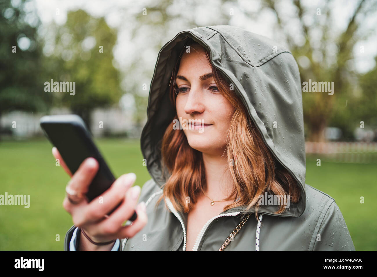 Young woman wearing a hood hi-res stock photography and images - Alamy