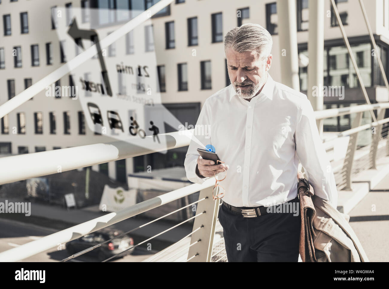 Mature businessman using cell phone for navigation in the city Stock ...