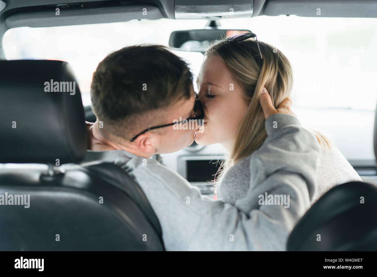 Young couple kissing in a car Stock Photo