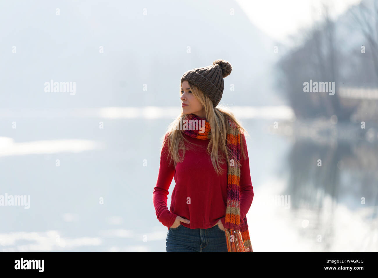 Young blond woman at a lake in winter Stock Photo