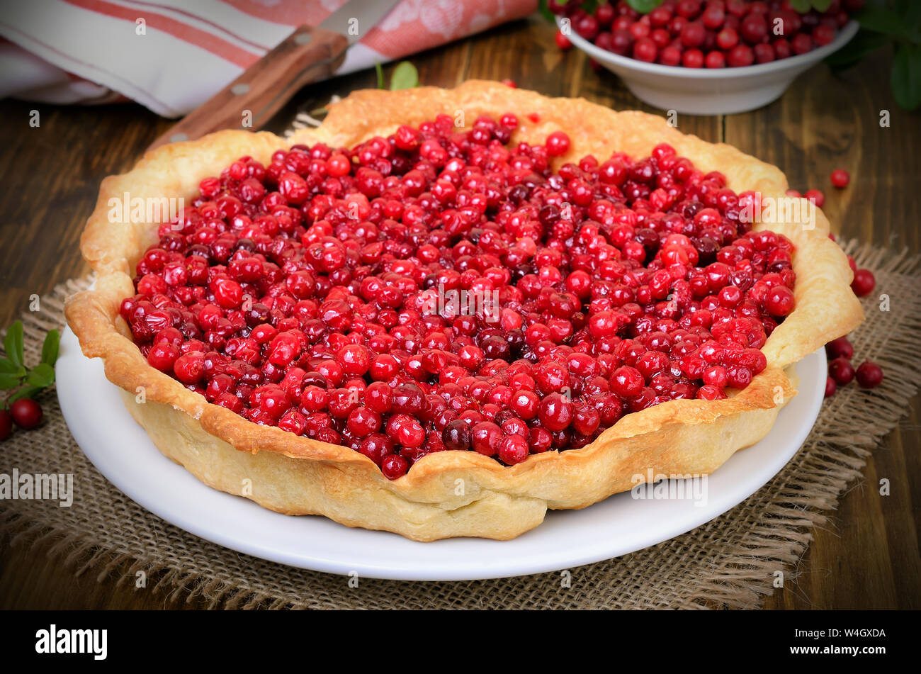 Appetizing cowberry pie on wooden table,close up Stock Photo