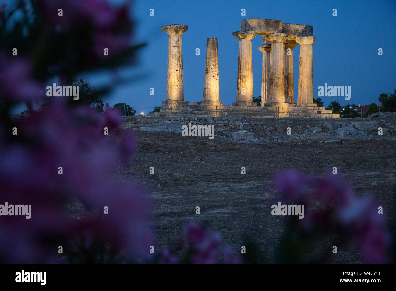 Archaic Temple of Apollo at blue hour, Dorian columns, Corinth, Greece Stock Photo