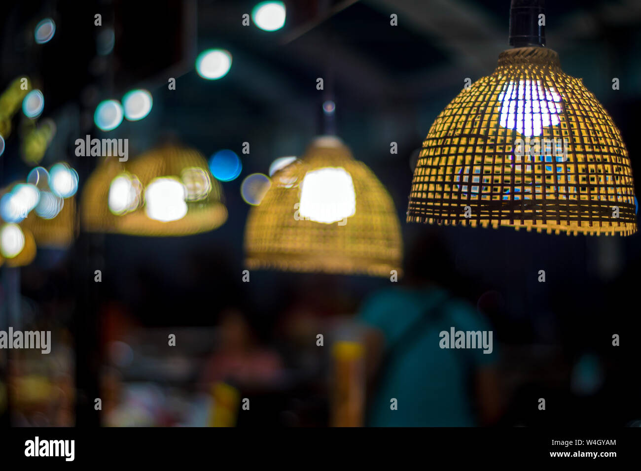 Warm tone lighting from the light bulb in the bamboo weave hanging lamp