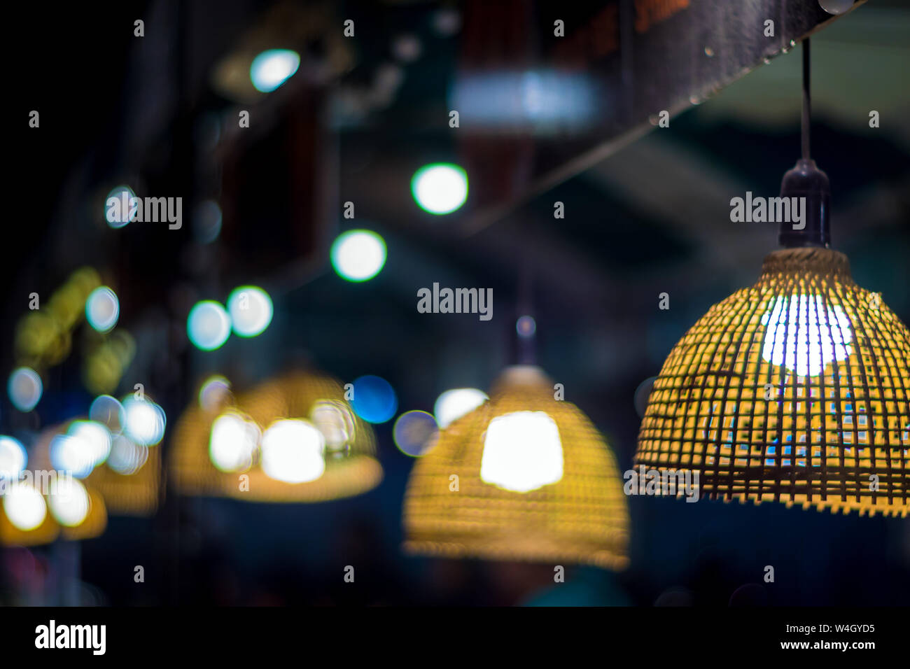 Warm tone lighting from the light bulb in the bamboo weave hanging lamp