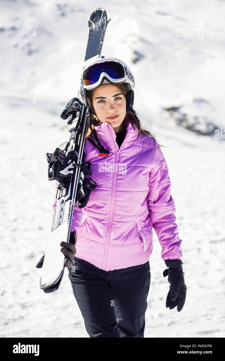 Portrait of woman carrying her skis over her shoulder, Sierra Nevada, Andalusia, Spain Stock Photo