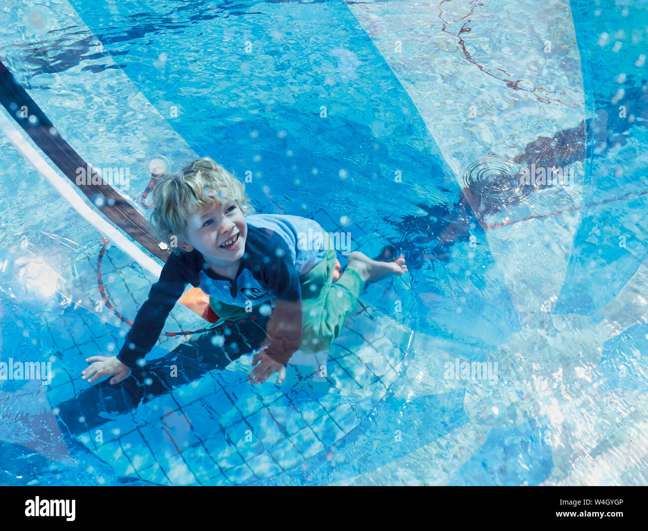 Portrait of little boy having fun with bech ball and swimming pool Stock Photo