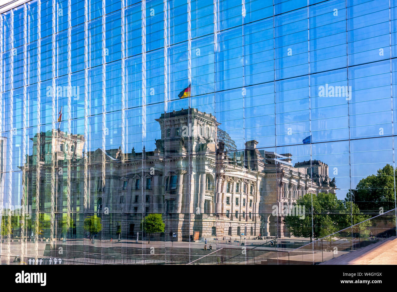 Germany, Berlin, Reichstag building mirrored in glass facade of Marie-Elisabeth-Lueders-Building Stock Photo