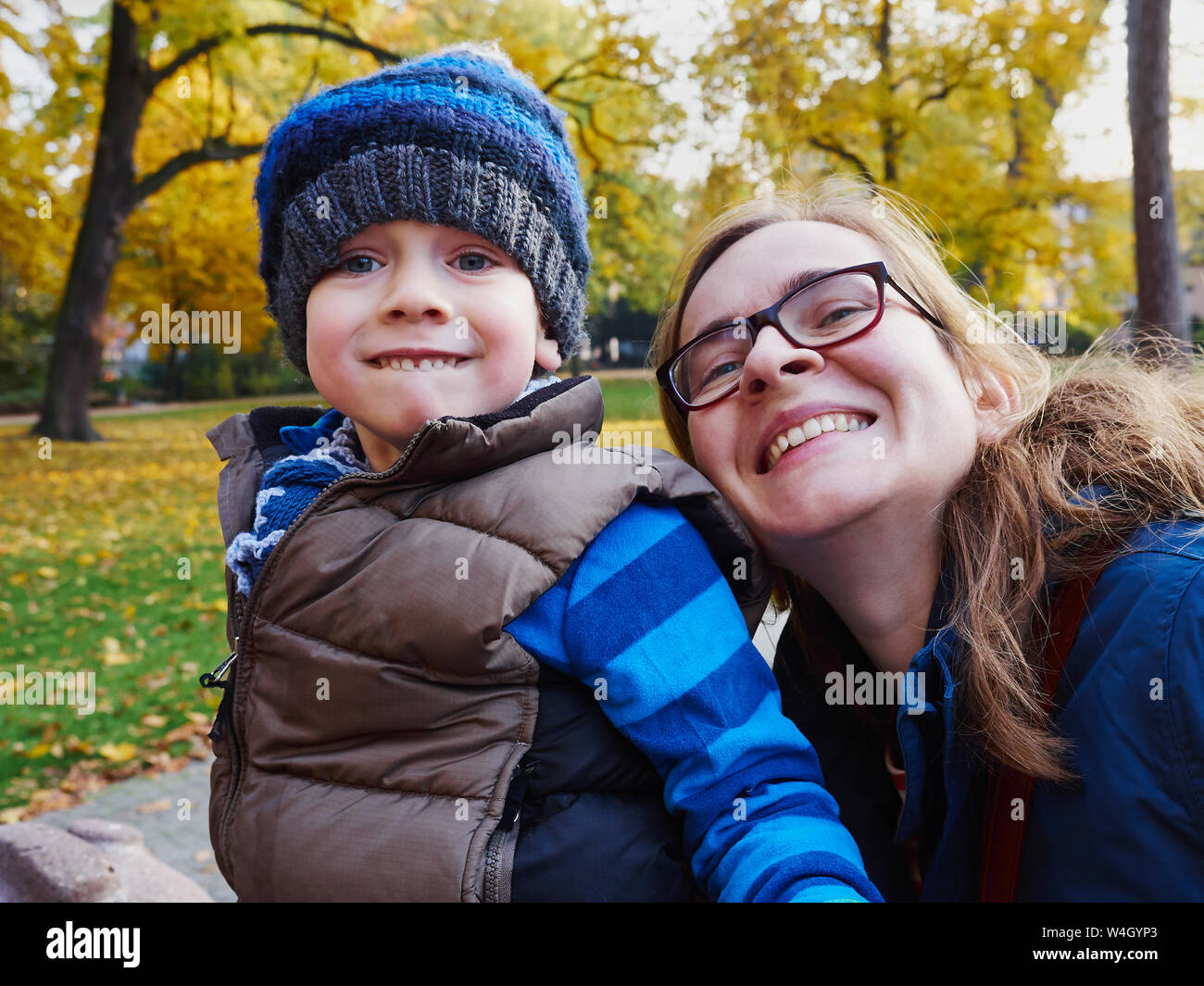 Portrait of mother and little son in an autumnal park Stock Photo