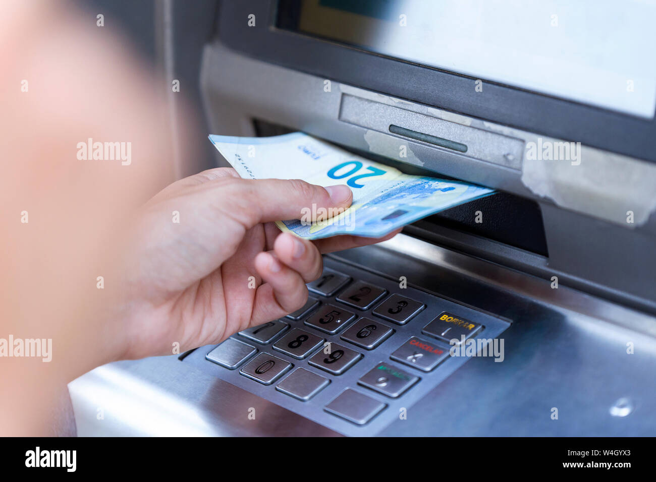 Close up of businesswoman withdraw money on a cash machine Stock Photo