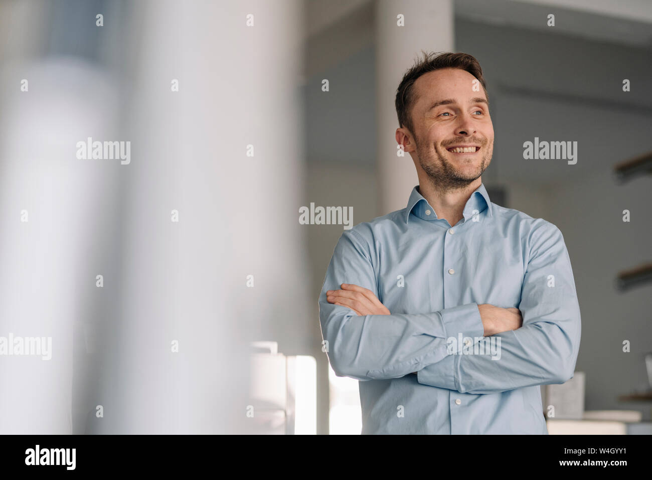 Portrait of a successful businessman, smiling with arms crossed Stock ...