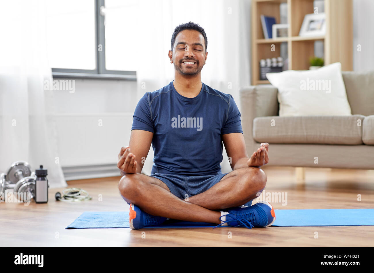 indian man meditating in lotus pose at home Stock Photo - Alamy