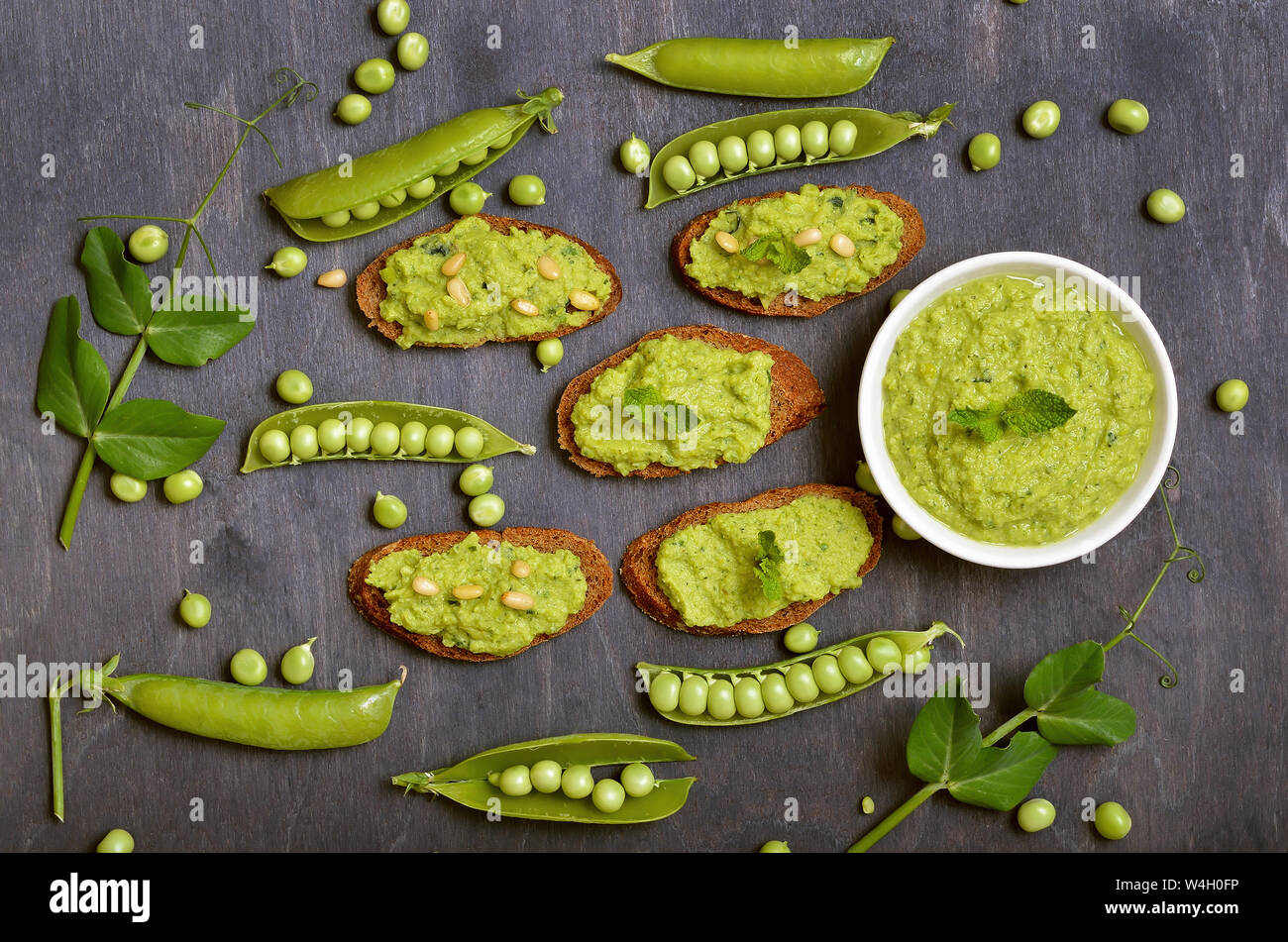Sandwiches with pesto sauce and pine nuts. Fresh green peas, top view Stock Photo
