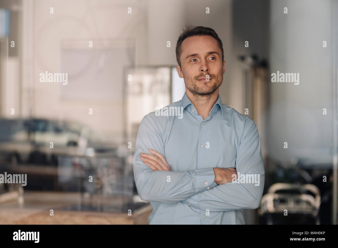 Portrait of a successful businessman, smiling with arms crossed Stock ...