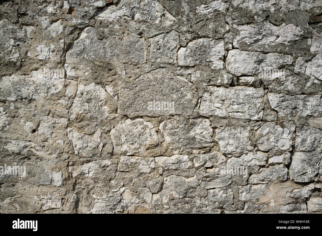 Old Grungy and Weathered Stone Wall Pattern Background Stock Photo
