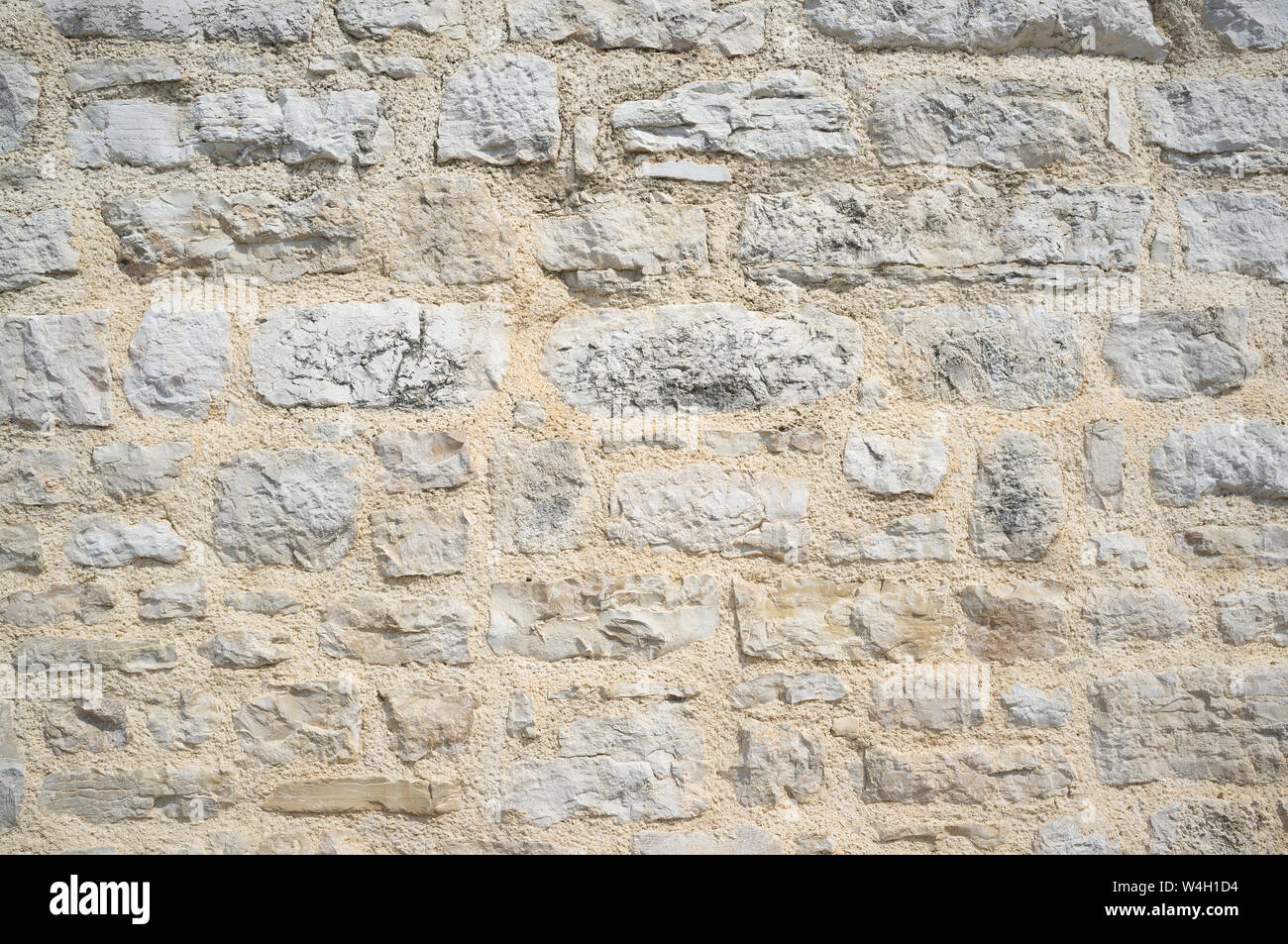 Old Grungy and Weathered Stone Wall Pattern Background Stock Photo