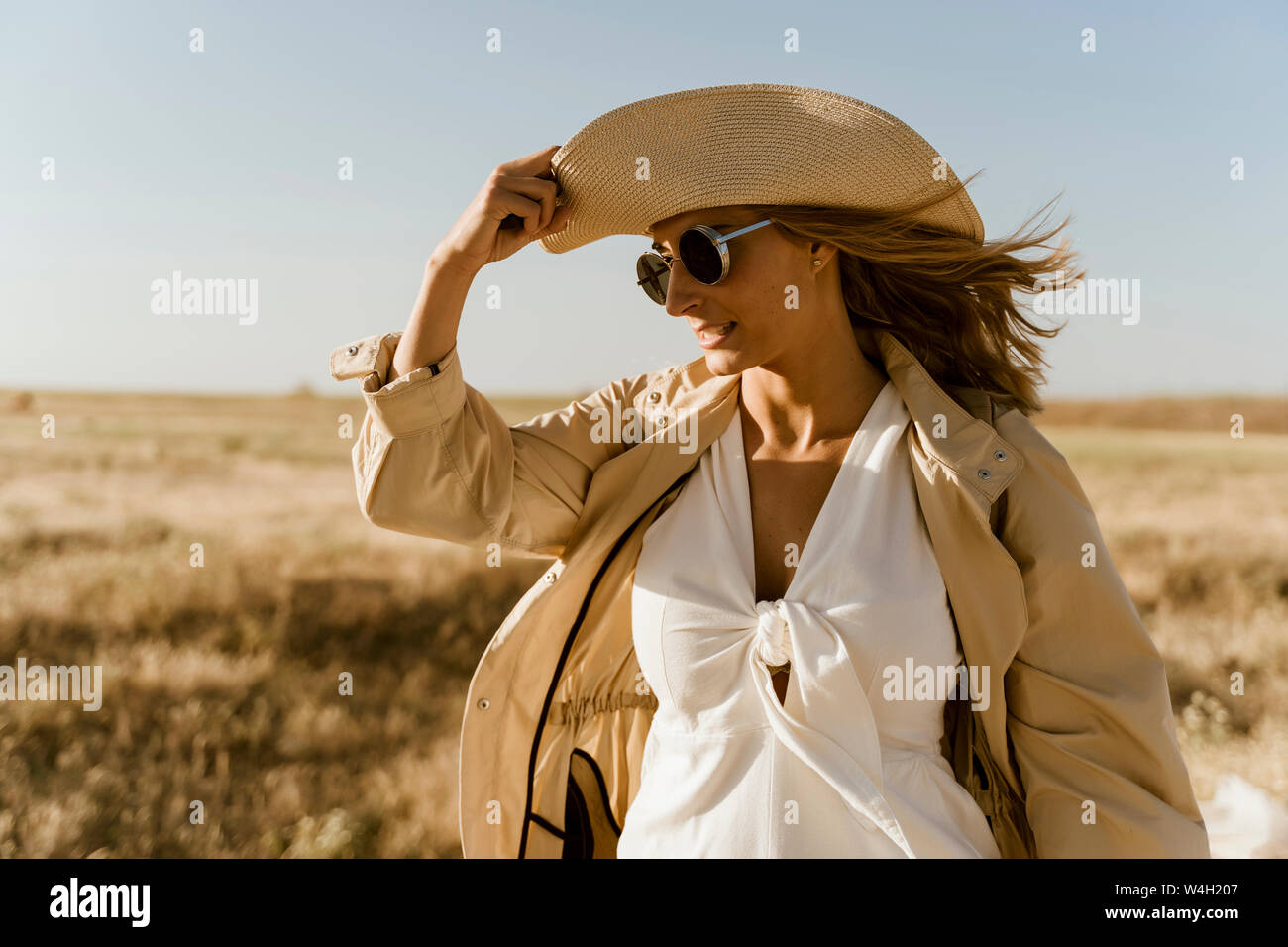 Female traveller with straw hat and sunglasses Stock Photo