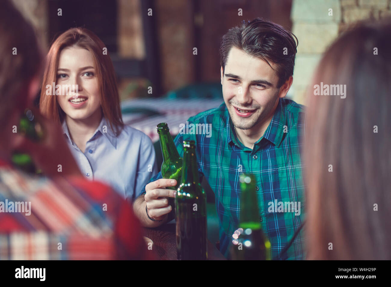 Group of friends sitting at bar hi-res stock photography and images - Alamy