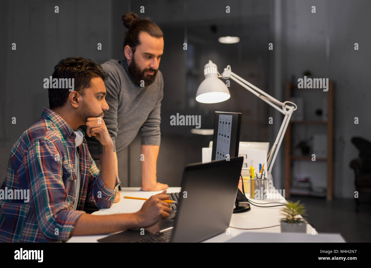 creative team with computer working late at office Stock Photo
