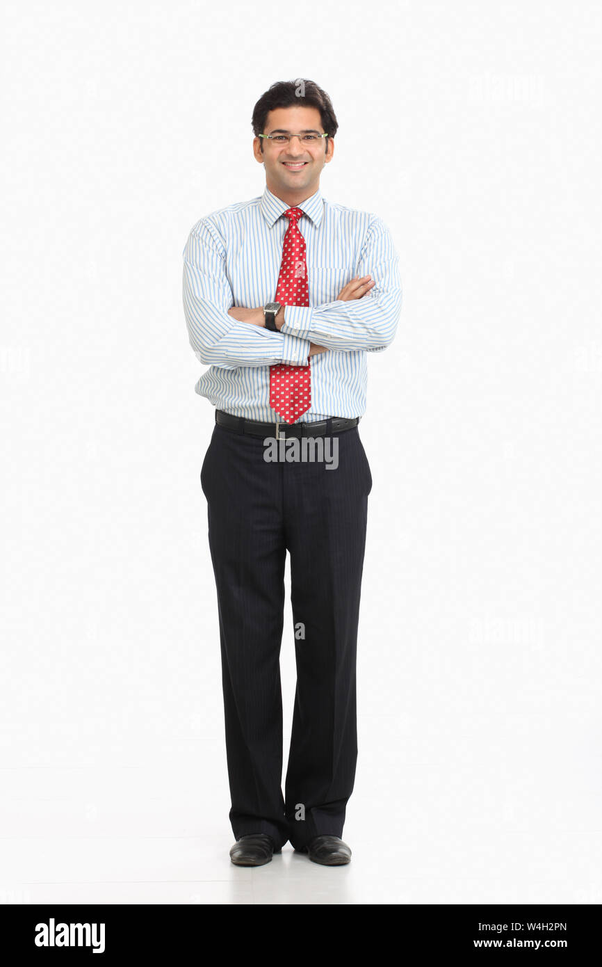 Businessman smiling with his arms crossed Stock Photo - Alamy
