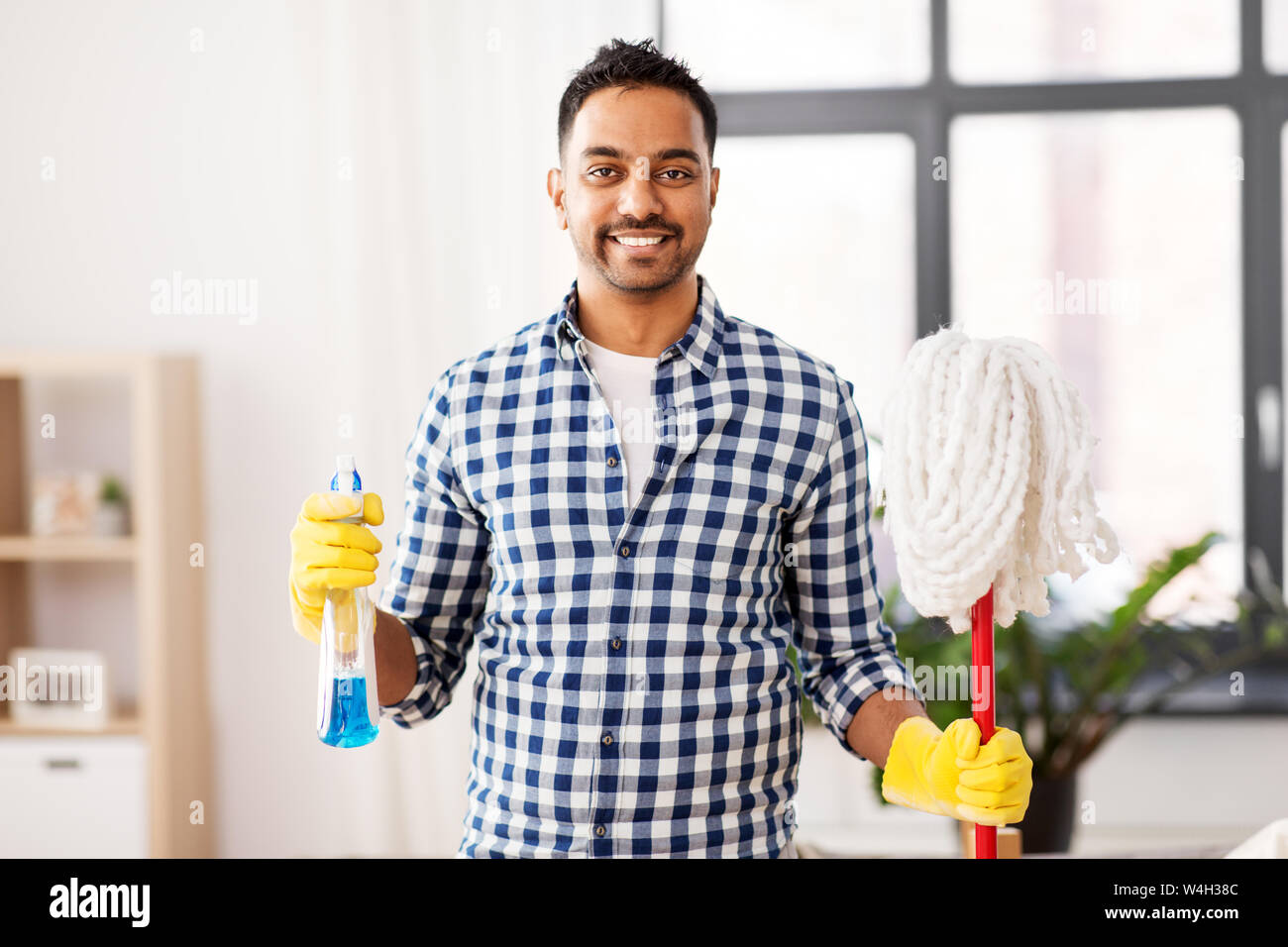 indian man with mop and detergent cleaning at home Stock Photo Alamy