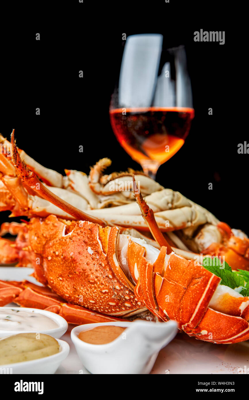 Fabulous lobster dish on wooden table with wine and all the finesse of ...