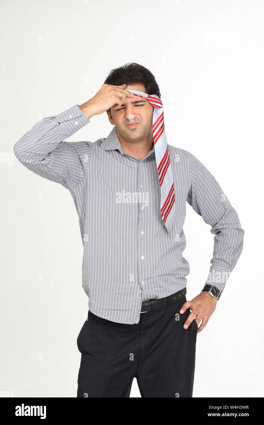 Indian businessman suffering from headache Stock Photo - Alamy
