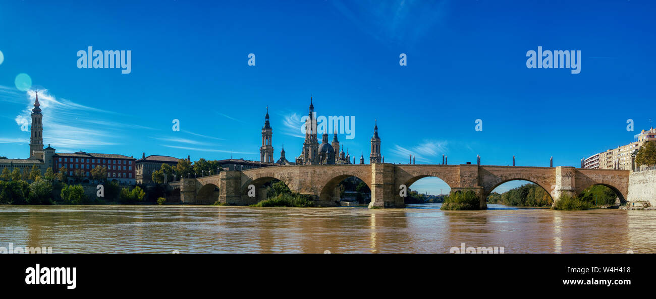 Landscape of the 'Puente de Piedra' Zaragoza, Spain, with the river Ebro. At the background we can see the towers of 'EL Pilar' Temple. Stock Photo