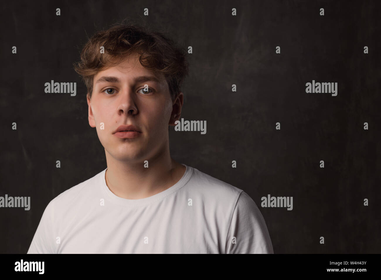 Handsome Young Man With A Stylish Haircut In A White Shirt On